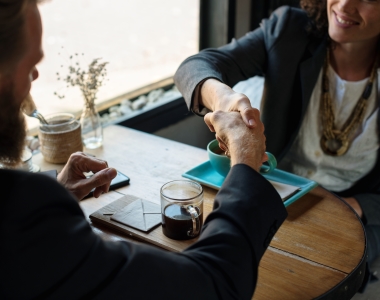 Business agreement handshake at coffee shop